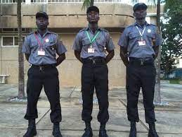 Four security personnel in uniform stand before a building, announcing 52 permanent security guard positions available at Sibanye-Stillwater.